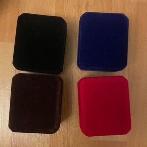 Set of 4 velvet jewelry boxes in black, burgundy, navy, and red
